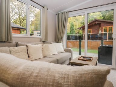 A living room with a sofa and table at Lake It Easy in Troutbeck Bridge