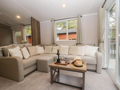 A living room with a sofa and coffee table at Lake It Easy in Troutbeck Bridge