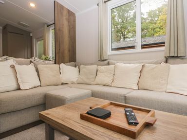 A living room with a sofa and coffee table at Lake It Easy Troutbeck Bridge