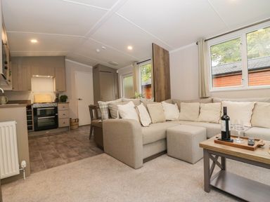 A living room with a sofa and coffee table at Lake It Easy in Troutbeck Bridge