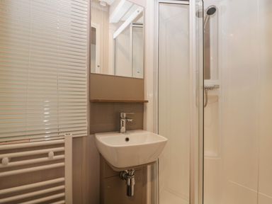 A bathroom with sink and shower at Lake It Easy in Troutbeck Bridge