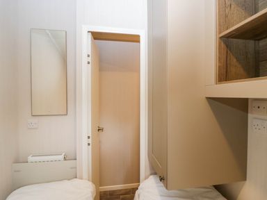 A utility room with a mirror and door at Lake It Easy Troutbeck Bridge