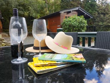 An outdoor area with wine glasses and hats at Lake It Easy in Troutbeck Bridge
