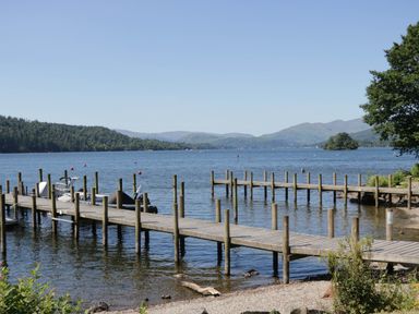 A dock with boats on water at Lake It Easy in Troutbeck Bridge