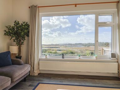 A living room with a view of the landscape at Bay View in Weymouth