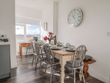 A dining room with a table set for dinner at Bay View in Weymouth