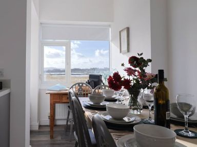A dining room with a table set for a meal at Bay View in Weymouth