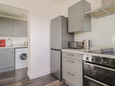 A kitchen with appliances and cabinetry at Bay View in Weymouth