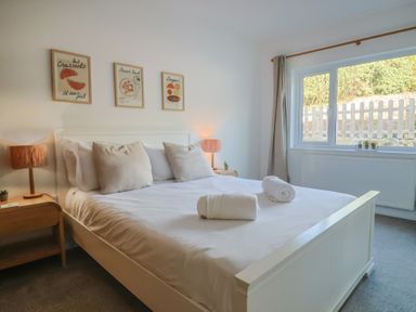 A bedroom with a bed and artwork at Bay View in Weymouth
