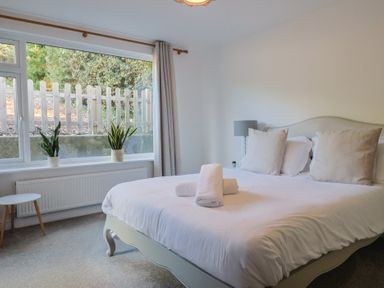A bedroom with a bed and window at Bay View in Weymouth