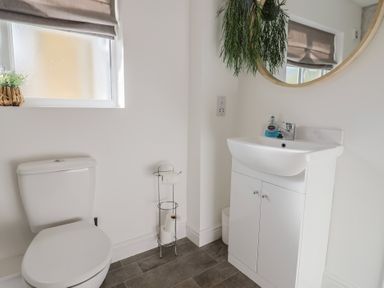 A bathroom with a toilet and sink at Bay View in Weymouth