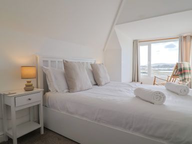 A bedroom with a bed and window at Bay View in Weymouth