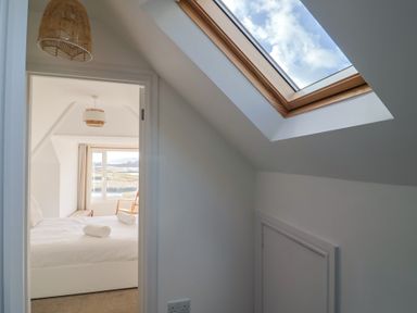 A bedroom with a bed and window at Bay View in Weymouth