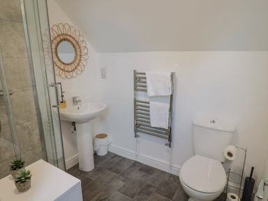 A bathroom with a sink, toilet, and shower at Bay View in Weymouth