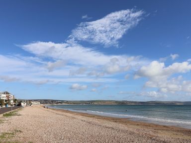 A beach with pebbles and sea at Bay View in Weymouth