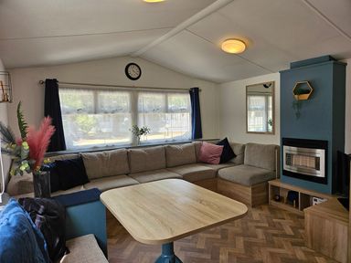 A living room with a sofa and a table at a property in unspecified location