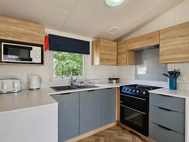 A kitchen with appliances and cabinets at The Old Barn in Manchester