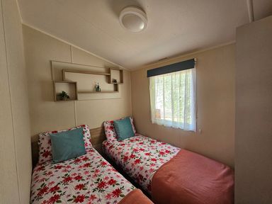 A bedroom with two beds and a window at the property in the location