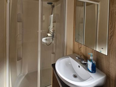 A bathroom with a shower and sink at The Old Barn in Manchester