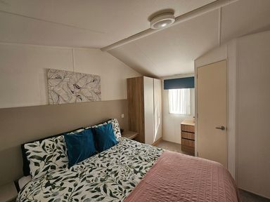 A bedroom with a bed and wardrobe at The Old Barn in Manchester