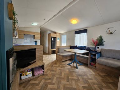 A living room with a sofa and table at a holiday cabin
