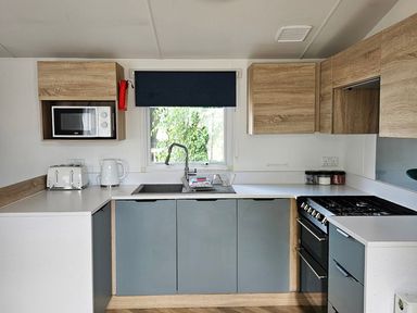 A kitchen with modern appliances at The Old Barn in Manchester