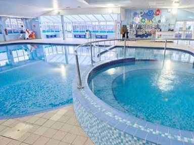 A swimming pool with a hot tub and seating area at 3 Bedroom Seafront Caravan, Sleeps 6 with Parking