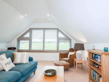 A living room with a sofa and armchair at 1 Endellion View Wadebridge
