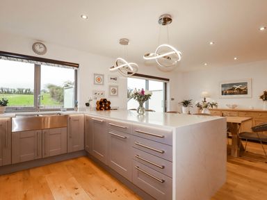 A kitchen with a sink and island at 1 Endellion View Wadebridge