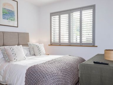 A bedroom with a bed and bedside table at 1 Endellion View Wadebridge
