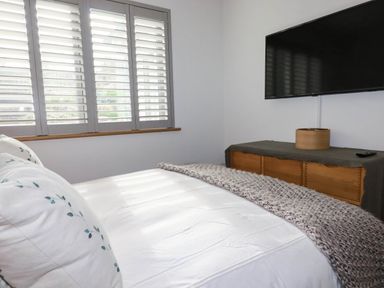 A bedroom with a bed and a television at 1 Endellion View Wadebridge