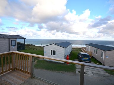 View of mobile homes and sea from a deck at Perran Sands Holiday Park - 615 Chy-an-Mor Perranporth