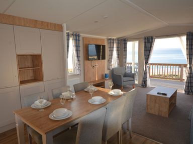 A dining room with a table and chairs at Perran Sands Holiday Park - 621 Chy-an-Mor, Perranporth