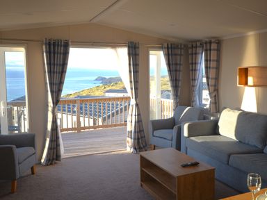 A living room with a view of the ocean at Perran Sands Holiday Park - 621 Chy-an-Mor Perranporth