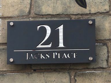 A house number sign for 21 Jacks Place on a wall in Whitby
