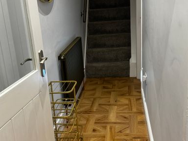 A hallway with a staircase and a radiator at Jacks Place in Whitby