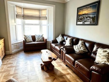 A living room with a sofa and armchair at Jacks Place in Whitby