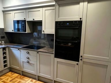 A kitchen with cabinets, cooktop, oven, and microwave at Jacks Place in Whitby