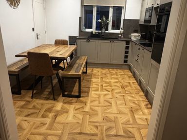 A kitchen with a dining table and benches at Jacks Place in Whitby