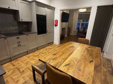 A dining room with a wooden table and chairs at Jacks Place in Whitby