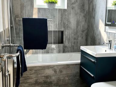 A bathroom featuring a bathtub, sink, and towel rail at Jacks Place in Whitby