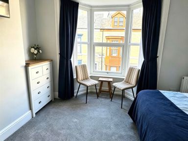 A bedroom with a window and seating area at Jacks Place in Whitby