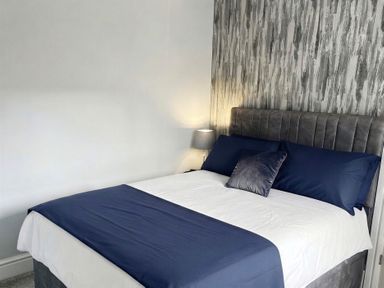 A bedroom with a bed and lamp at Jacks Place in Whitby