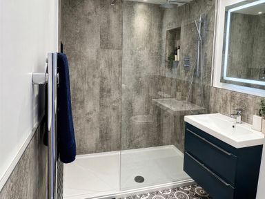 A bathroom with a shower, sink, and towel rack at Jacks Place in Whitby