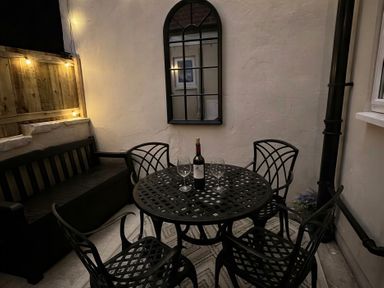 An outdoor seating area with a table and chairs at Jacks Place in Whitby