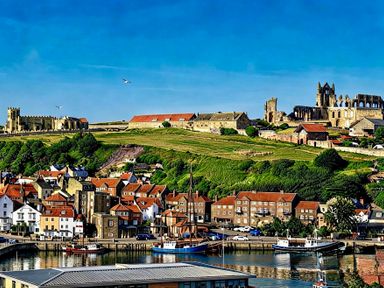 A view of buildings and boats along a river at Jacks Place in Whitby