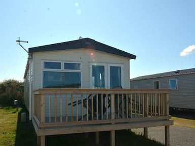 A holiday home with a wooden deck at Perran Sands Holiday Park - 725 Kernow View Perranporth