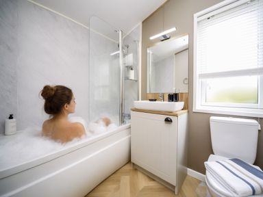 A bathroom with a bathtub, sink, and toilet at Hoburne Devon Bay - Woodland Glade 24, Paignton