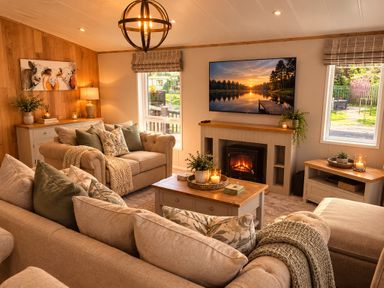 A living room with a sofa, television and fireplace at Hoburne Devon Bay - Woodland Glade 24 in Paignton