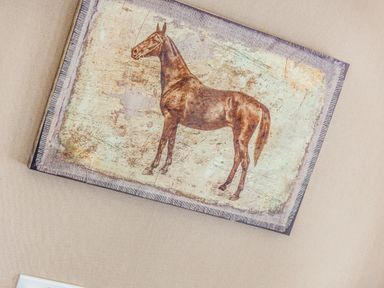 A rectangular artwork featuring a horse on a beige wall at Lavender Lodge in Charlton Horethorne near Sherborne